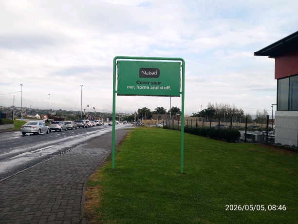 Naked Insurance "Cover your car, home and stuff" street pole ad on a grass verge