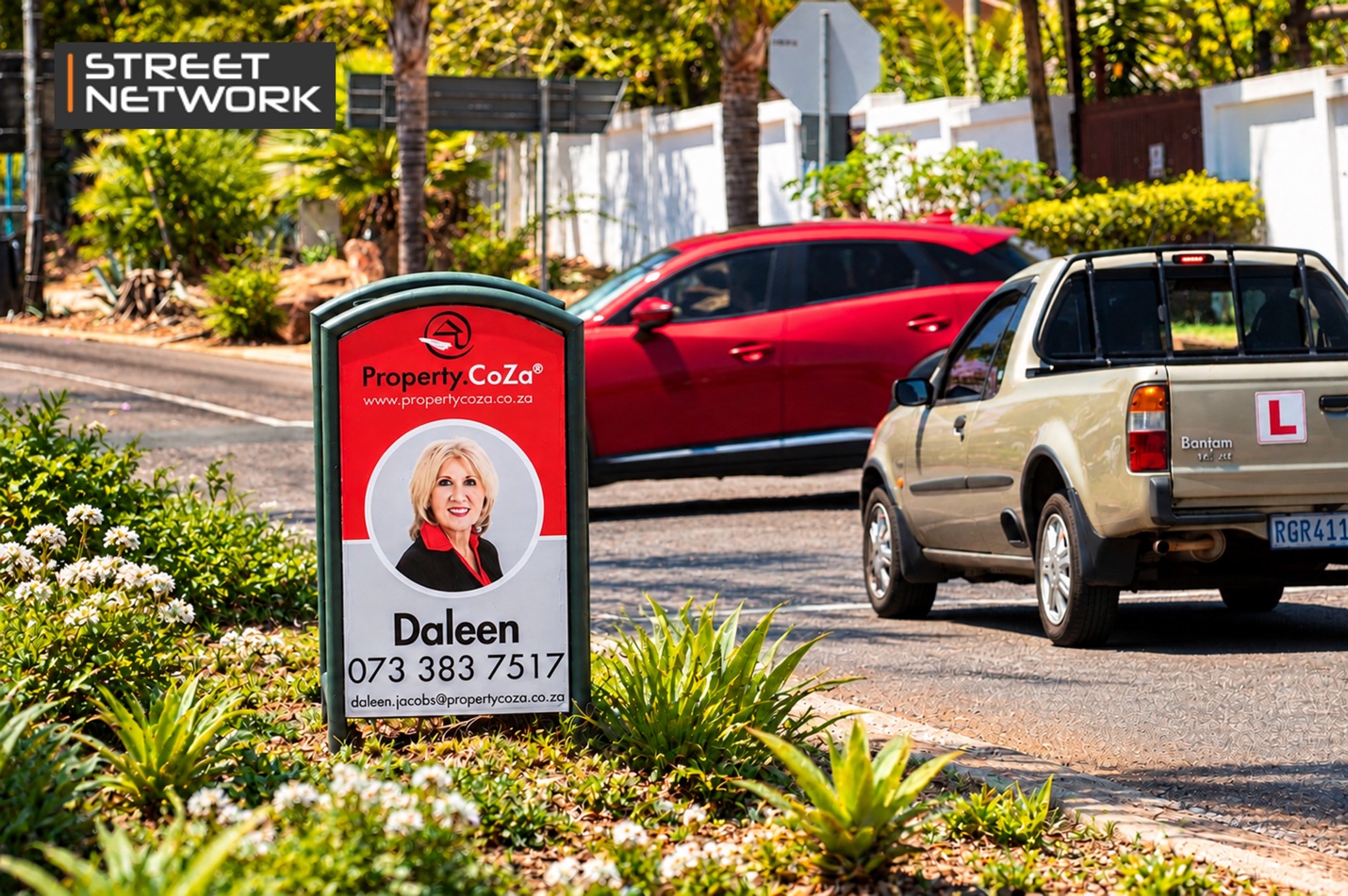 Street Network advertising bin with a Property.co.za estate agent ad beside a suburban road
